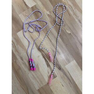 Two little girls jump ropes